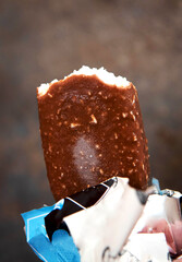 Ice cream on a stick in chocolate glaze. Bitten ice cream