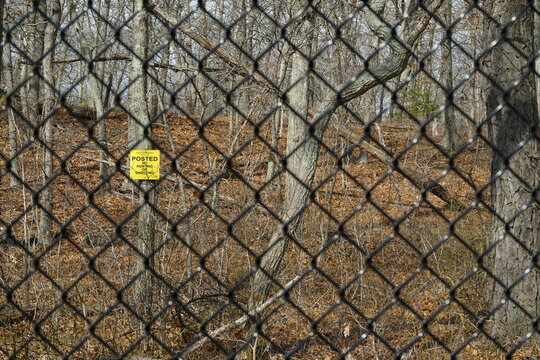 Black chain link fence with No Hunting Sign