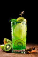 kiwi cocktail lemonade in a dark bar, Fresh kiwi cocktail with mint. Summer cold drink and cocktail