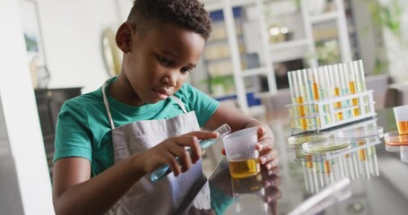 Video of african american boy doing experiments at home - Powered by Adobe