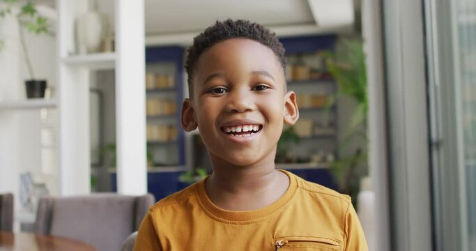 Video of happy african american boy looking at camera