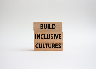 Build Inclusive Cultures symbol. Wooden blocks with words Build Inclusive Cultures. Beautiful white background. Business and Build Inclusive Cultures. Copy space.