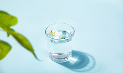 Fresh clear water drink with white flower apple tree in glass