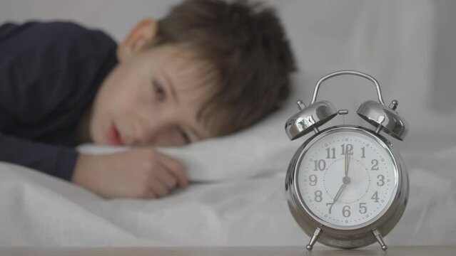Kid wakes up by clock ringing, late for school