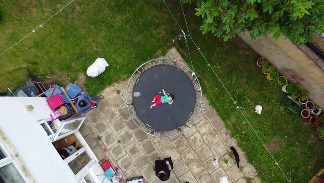 Cute Baby Enjoying on Trampoline with his Grand dad, Drone's Footage