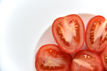 Sliced red tomato on a white plate