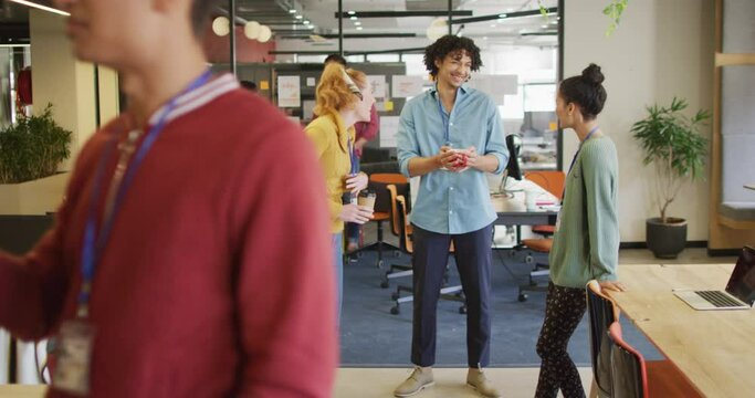 Happy diverse business people discussing work during meeting at office