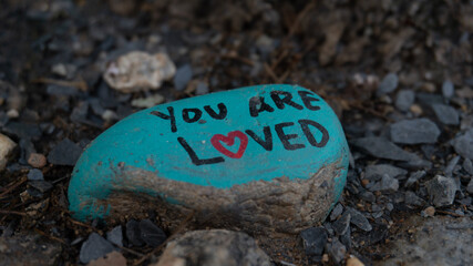 you are loved paint on a rock