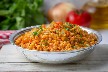 Traditional turkish bulgur pilaf with tomato sause in plate (Turkish name; meyhane pilavi)