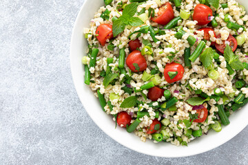 Tabbouleh salad. Tabouli salad with fresh parsley, onions, tomatoes, bulgur and green beans. Healthy vegetarian food, diet