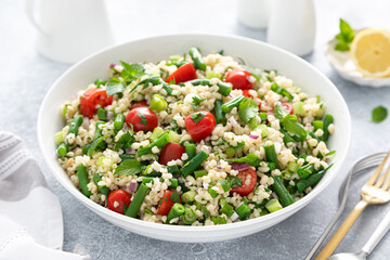 Tabbouleh salad. Tabouli salad with fresh parsley, onions, tomatoes, bulgur and green beans....