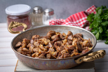 Muslims Traditional Sacrifice holiday food lamb, Turkish roasted meat in copper pot on table top. Turkish Kavurma. (Turkish name; Kurban kavurma)
