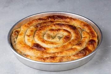 Obraz na płótnie Canvas Turkish Tepsi Boregi, Round Borek, Tray pastry (Turkish name; rulo borek)