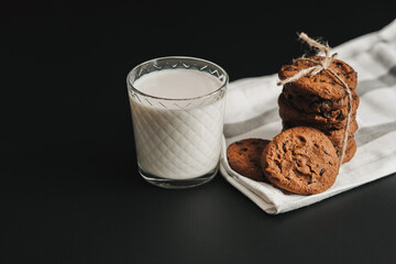 Glass is Filled with Milk and Homemade Cookies on the Black Table