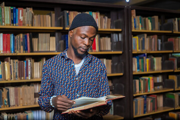 close up of a handsome international student reading in the library