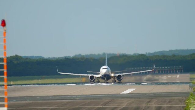 Front view passenger airplane departure at Dusseldorf airport (DUS). Tourism and aviation concept