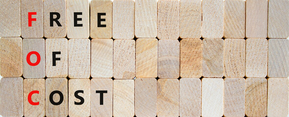FOC free of cost symbol. Concept words FOC free of cost on wooden blocks on a beautiful wooden background. Business and FOC free of cost concept. Copy space.
