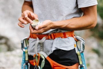 Male Hiker Holding Balm Standing With Harness