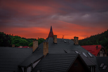 Fototapeta Recreation building and roofs in Karpacz mountain town in spring evening obraz