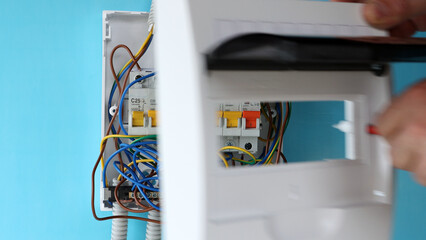 Repairing of electrical panel with fuse box in home wiring system.