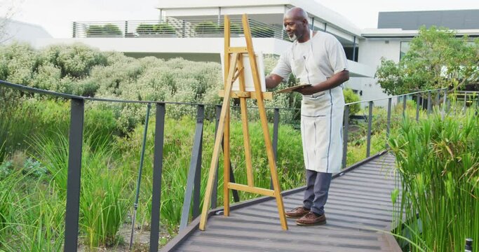 Video of happy senior african american men painting