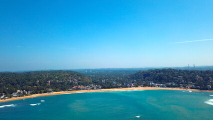 Obraz premium Beach coastline in Unawatuna, Sri Lanka. Popular destination for tourists visiting Sri Lanka. Situated close to Galle and Mirissa