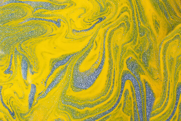 Shimmer yellow and blue background,make from liquid nail polishes.Good as cosmetics backdrop.