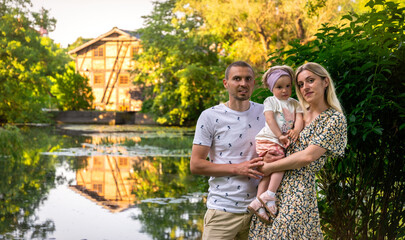 Happy family resting in a summer park