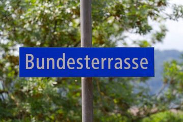 Blue and white road sign with text Bundesterrasse (German, translation is Federal Terrace) at the old town of Bern on a sunny summer day. Photo taken June 16th, 2022, Bern, Switzerland.