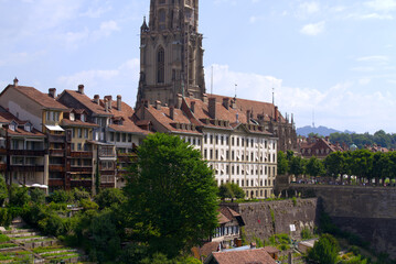 Fototapeta premium Aerial view of the old town of City of Bern with historic houses, Minster and Aare River on a blue cloudy summer day. Photo taken June 16th, 2022, Bern, Switzerland.