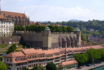 Fototapeta premium Aerial view of the old town of City of Bern with historic houses, Minster and Aare River on a blue cloudy summer day. Photo taken June 16th, 2022, Bern, Switzerland.