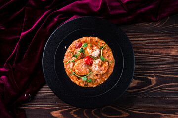 classic italian risotto with shrimps and prawns on a wooden background