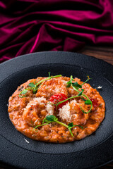 classic italian risotto with shrimps and prawns on a wooden background