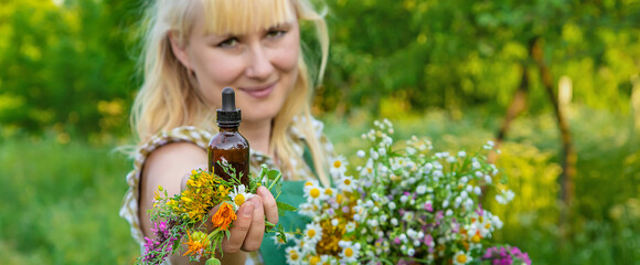 A woman makes herbal tincture. Selective focus.