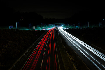 Long exposure photo showing cars moving at pace along both sideways of the motorway