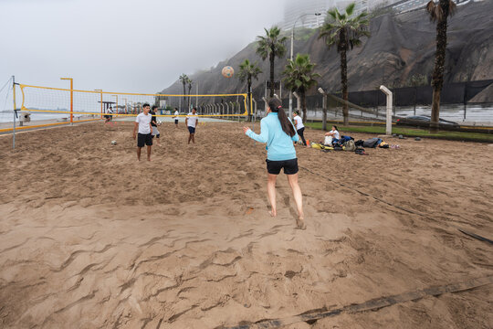 Group of people playing footvolley on the beach