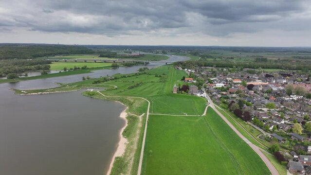 Heteren village on the river Lower Rhine in the Dutch province of Gelderland aerial drone view of the river and dyke waterway and buildings along the water. Overbetuwe