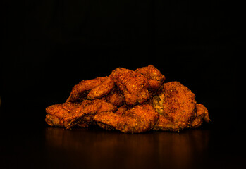 Spicy chicken wings with black background
