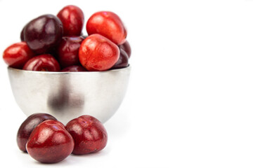 sweet cherry in a cup and a berry next to it on a white background. Greeting card with copy space. The concept of vitamins, proper nutrition, agriculture, harvest.. High quality photo