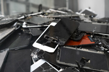 A heap with the broken screens lying one on top of another. Devices are prepared for utilization