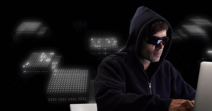 Animation of data processing and caucasian male hacker using laptop on black background