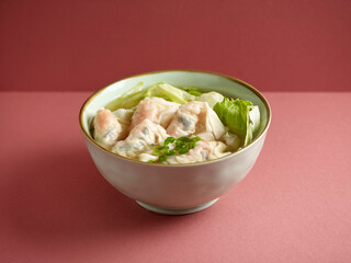 Prawn Dumpling soup with chopsticks served in a bowl isolated on mat side view on grey background