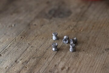 Munition for airguns / lead pellets on a wooden prank 