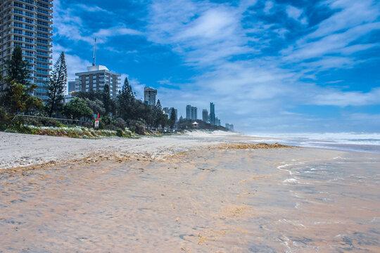 Wide beach with tide going out and city stretching to horizon - Gold Coast Australia