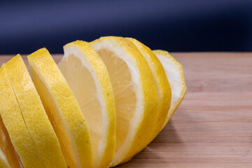 lemon cut on cutting board with black background