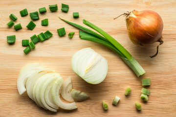 Onions on a wooden cutting board.