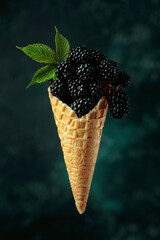 Fresh blackberries in a waffle cone.