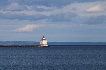 Sun shining on the lighthouse that guides the vessels of the Great lakes - Thunder Bay Marina, Ontario, Canada