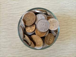 Pakistani currency coins in a glass with white background