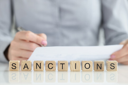 Text sanctions list on white note paper